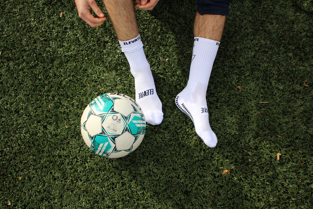 Footballer using Elevate grip socks to boost football performances.